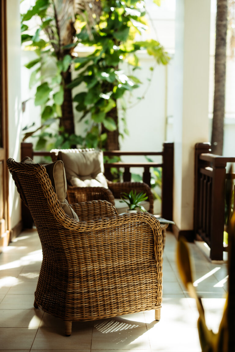 A peaceful spot to relax on the private balcony of a room at Athena Hotel Pakse, featuring comfortable seating and greenery.