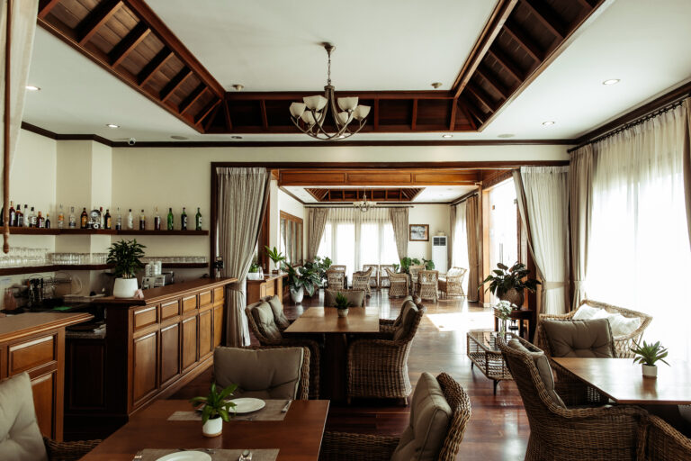 The beautifully decorated interior of the all-day dining restaurant at Athena Hotel Pakse, with tables set for service
