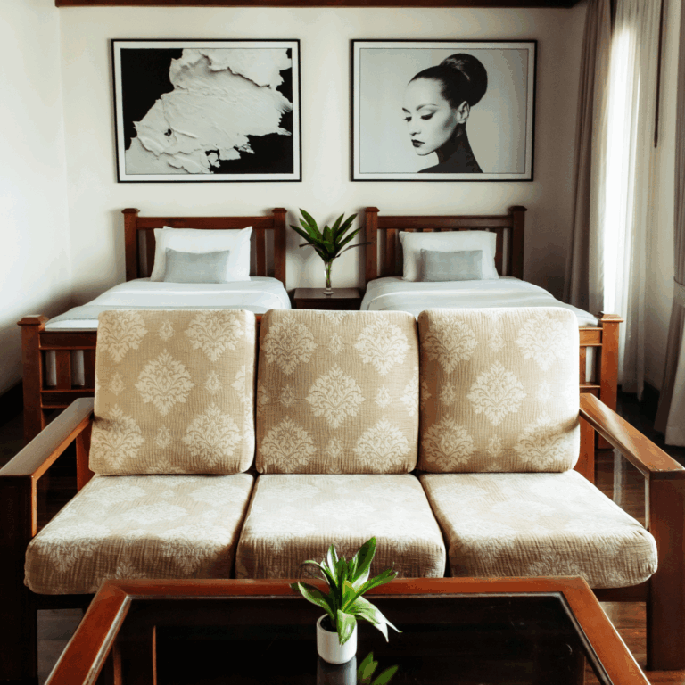 Elegantly decorated twin room at Athena Hotel Pakse, with classic wooden furniture and unique black and white art above the beds.